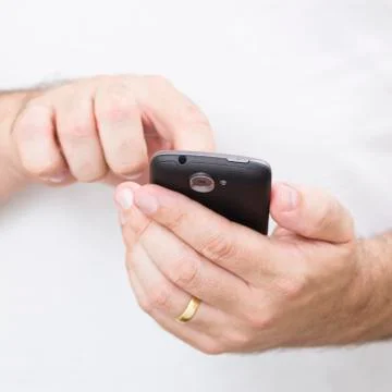 A man using a touchscreen phone Stock Photos