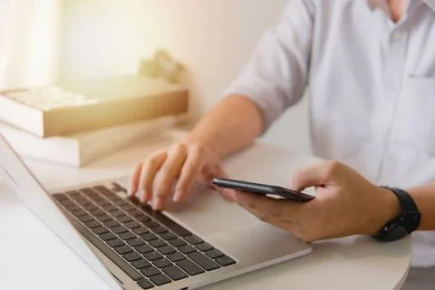 Man using touchscreen smartphone to stay connected, browse the internet, ac.. Stock Photos
