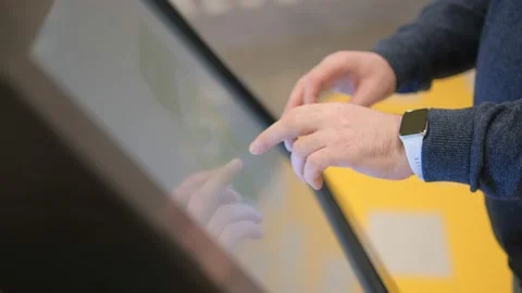 Man using touchscreen terminal in mall. Detail view outstretched male hand Stock Footage 232391026