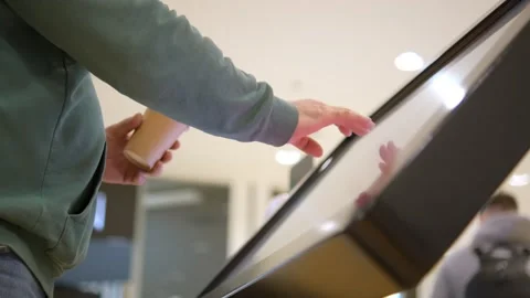Man using touchscreen terminal in mall. Detail view outstretched male hand Stock Footage 243146579