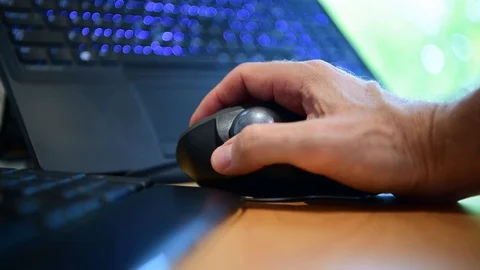 Man using a track ball mouse to operate a computer Stock Footage 105628469