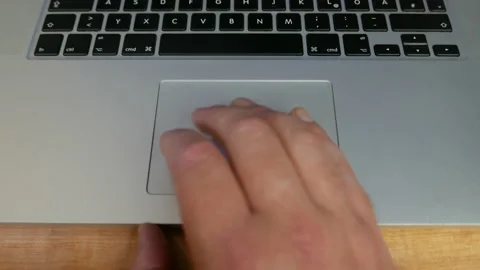 Man using the trackpad on an Apple MacBook Pro laptop computer. Stock Footage 223375418