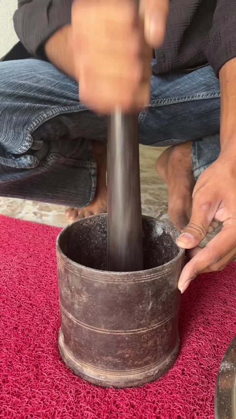 Man Using Traditional Iron Mortar and Pestle 스톡 동영상 331987550