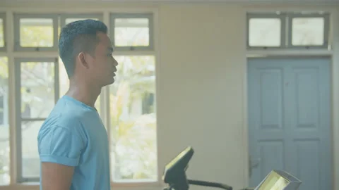 A Man Using Treadmill in Small Gym Stock Footage 162169370