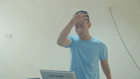 A Man Using Treadmill in Small Gym Stock Footage 162175415