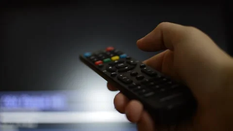 Man using tv remote and switch channels of the television. Stock Footage 218606605