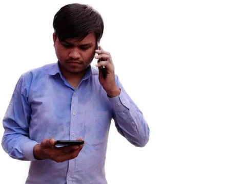 Man using two mobile phones talking and typing on cell, Indian men in Blue sthit Stock Photos