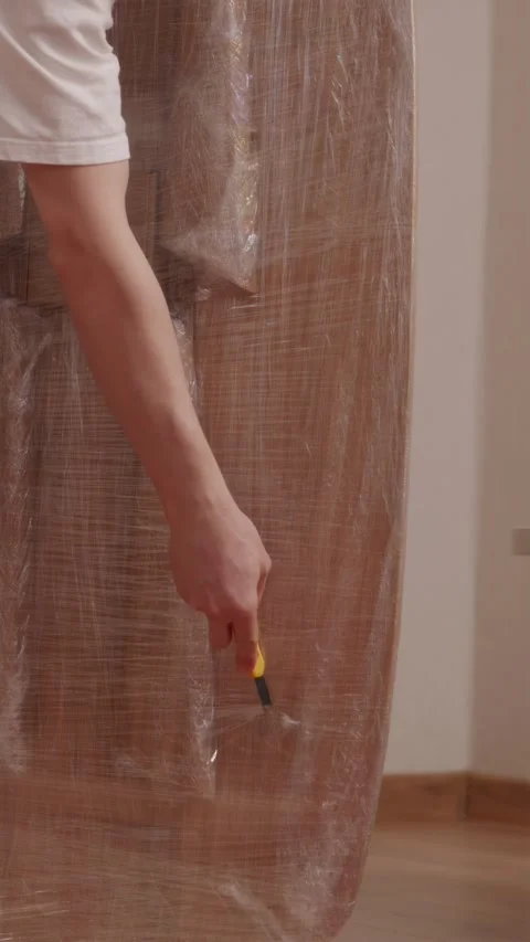 Man using utility knife to open delivered wooden table box Stock-Footage 346396406