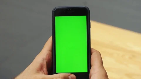 Man using vertical smartphone with green screen. Close-up shot of man's hands Stock Footage 85029477