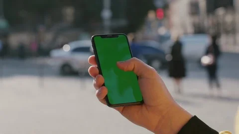 Man using a vertical smartphone mobile application on mock-up greenscreen Stock Footage 117428134