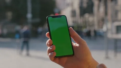 Man using vertical smartphone swiping on mobile mock-up greenscreen application Stock Footage 117427777