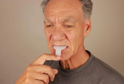 Man using a Vibration Bite device for pain relief Stock Photos