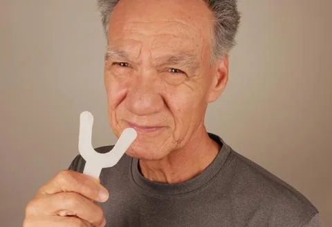 Man using a Vibration Bite device for pain relief Stock Photos