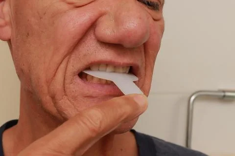 Man using a Vibration Bite device for pain relief Stock Photos