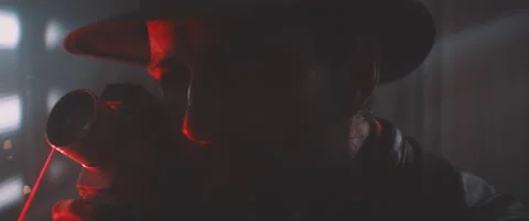 Man using vintage camera in red laser light Stock Footage 203565391