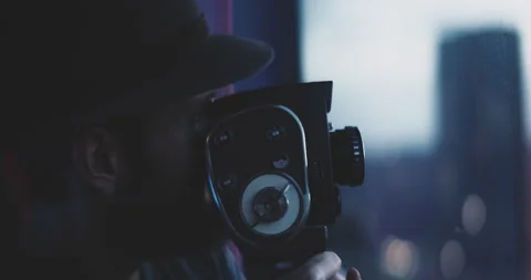 Man using vintage camera turns to look into the camera and smiles Stock Footage 203578818