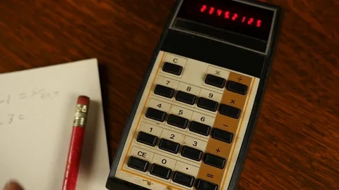 A man using a vintage electronic calculator Stock Footage 82878589