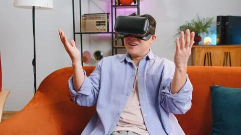 Man using virtual reality futuristic technology headset to play simulation 3D Stock Photos