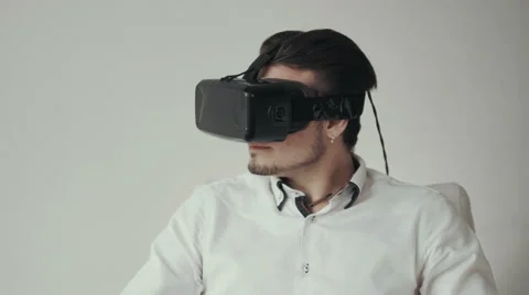 Man Using Virtual Reality Glasses. Special Headset. Isolated on White Bckground Stock Footage 62517845