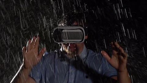 Man using virtual reality glasses in the rain. Technology VR. Slow motion Stock Footage 79502016