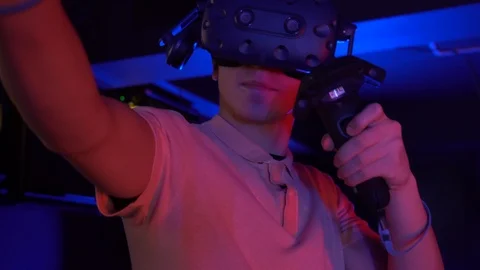 Man using virtual reality headset and controllers. Gaming in virtual relaity. Stock Footage 124365559