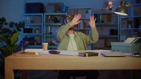 Man Using Virtual Reality Headset At Desk Video stock 318360579