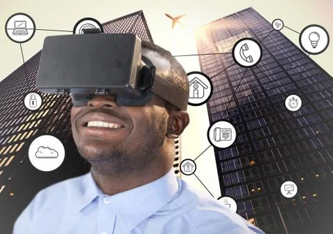 Man using virtual reality headset with connecting icons and skyscrapers in Stock Photos