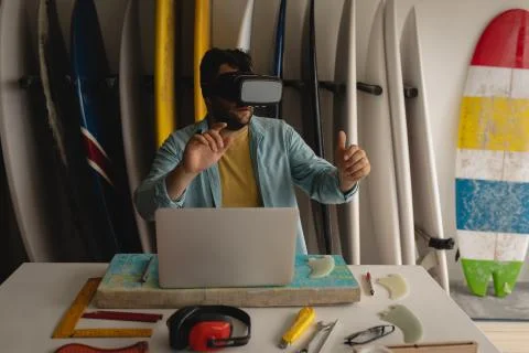Man using virtual reality headset in a workshop Stock Photos