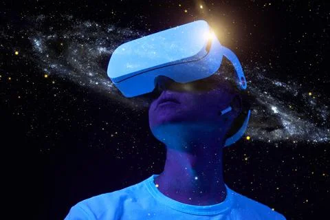 Man is using virtual reality headset. Elements of this image furnished by NASA. Stock Photos