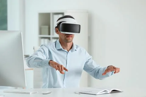 Man using virtual reality headset in office Stock Photos