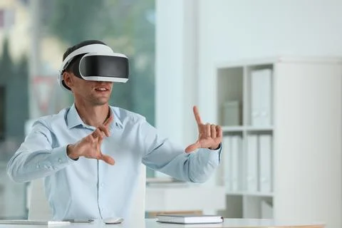 Man using virtual reality headset in office Stock Photos