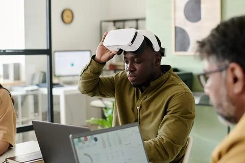 Man Using Virtual Reality Headset in Office Setting Stock Photos