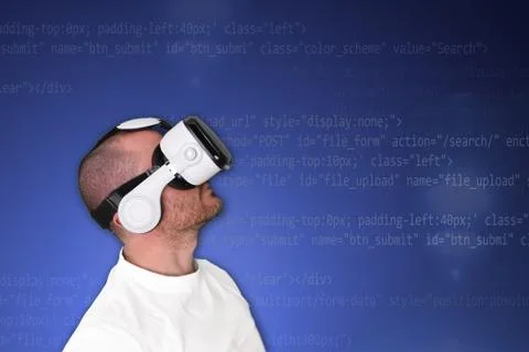 A man using a Virtual Reality VR glasses against a programming code background. Foto stock