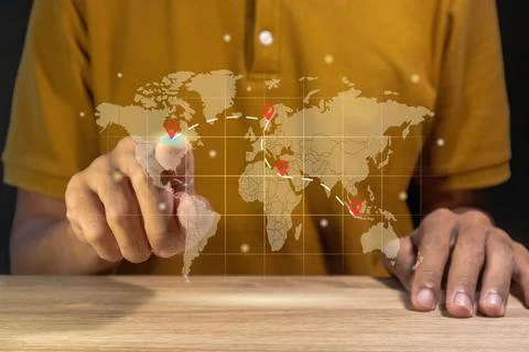 Man using a virtual world map to plan a trip between countries Stock Photos