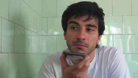 Man using vocal assistant and sending vocal message. Man using technology  Stock Footage 197470280