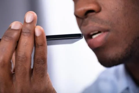 Man Using Voice Assistant On Cellphone Stock Photos