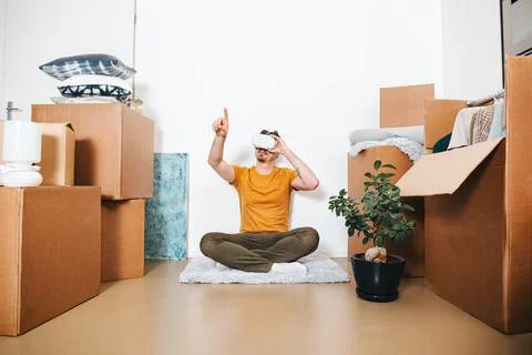 Man Using VR During Home Move Besides Moving Boxes Stock Photos