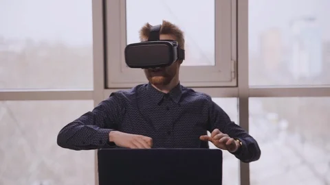 Man using vr glasses at the office. Exited man looking aroung and touching Stock Footage 119454904