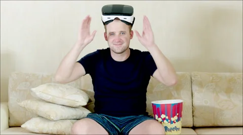 Man using VR glasses sitting on the sofa Stock Footage 62729818