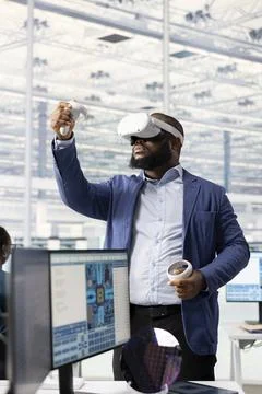 Man using VR goggles hardware, analyzing semiconductors layout in RD office Stock Photos