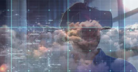 Man using VR headset exploring digital cloud technology in modern office Stock Photos