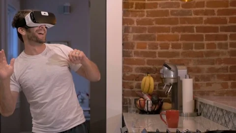 Man using VR headset giving virtual round of high fives to an imaginary crowd Stock Footage 81844423