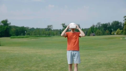 A man using a VR headset in the park, comes back, talks and smiling Video stock 112810078