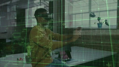 Man using VR headset reaching forward at loft office, showing green grid Stock Footage 309104042