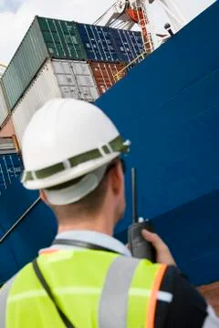 Man Using Walkie Talkie At Container Terminal Stock Photos