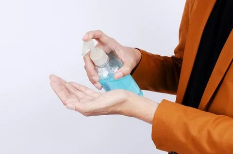 Man using wash hand sanitizer gel pump dispenser prevent the virus COVID-19.. Stock Photos