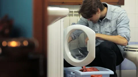 Man using washing machine and doing chores Stock-Footage 1051943