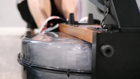 Man using a water rowing machine for exercise Stock Footage 329649793