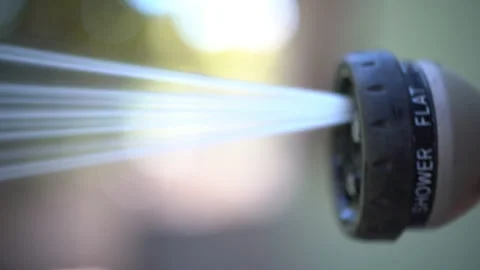 Man Using Watering Hose Hand Sprinkler To Spray Water. Stock Footage 166815246