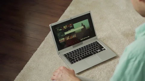 Man using web search engine on laptop at home Stock Footage 128814321